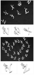 Detailed macro view of silver stainless steel A-Z alphabet pendants on a black leather texture