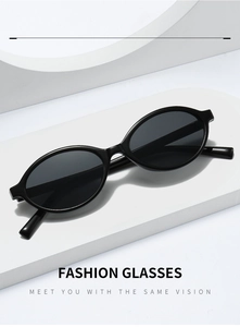 Detail view of oval black sunglasses frames with sleek polished finish and dark lenses