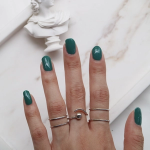 Detail of S925 sterling silver minimalist double line and beaded rings on hand