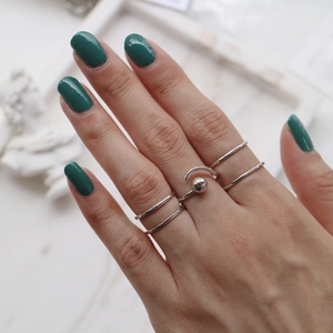 Close-up of minimalist S925 sterling silver double-line open ring set on a model hand