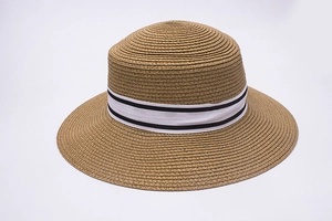 Detail of fine woven straw sun hat with elegant black and white striped grosgrain ribbon