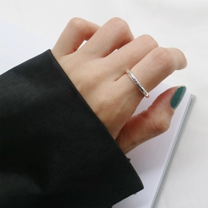 Detail of S925 sterling silver smile ring worn on hand with minimalist aesthetic
