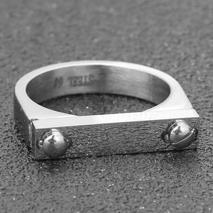 Macro detail of industrial style 4mm stainless steel ring with dual rivet design