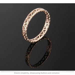 Close-up of rose gold titanium steel ring featuring hollow heart-shaped patterns