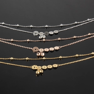 Detailed view of bead necklaces in silver, rose gold and gold finish with coin pendants