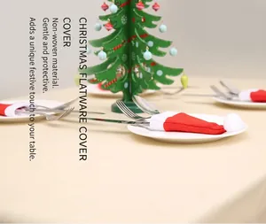 Close-up of red and white non-woven Christmas mini hat silverware and cutlery holders