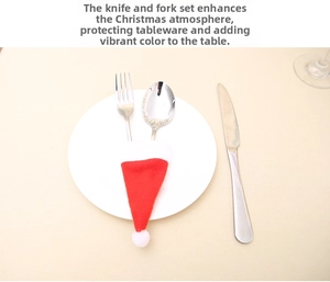 Mini Santa hat cutlery holder in red and white fabric on a plate for Christmas dining decor
