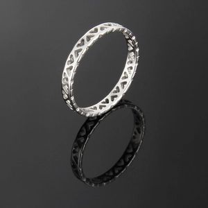 Polished silver stainless steel ring with hollow heart cut-outs on reflective surface