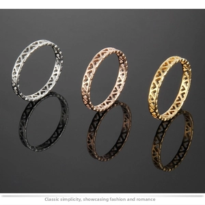 Detailed close-up of cutout heart patterns on rose gold, gold, and silver titanium rings