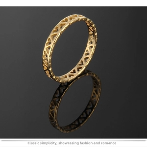 Detailed view of cutout heart patterns on polished rose gold titanium steel ring