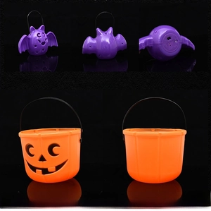 Detail view of Halloween pumpkin bucket and purple bat lantern with bottom battery compartment