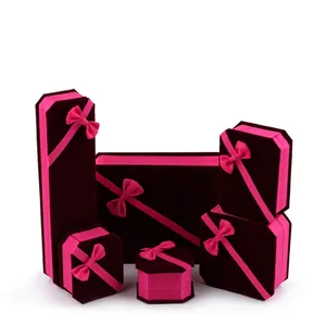 Elegant velvet jewelry box set in deep purple with pink ribbon for rings and necklaces