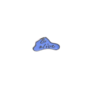 Cartoon blue enamel pin with Be Alive text on a clean white background