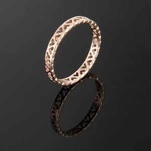 Elegant rose gold hollow heart titanium steel ring displayed on a dark mirror background