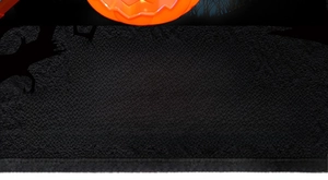 Detail showing glowing orange Halloween pumpkin lantern with Happy Halloween typography