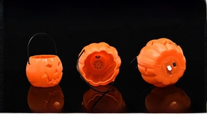 Detail view of Halloween pumpkin lantern showing inner speaker and bottom battery compartment