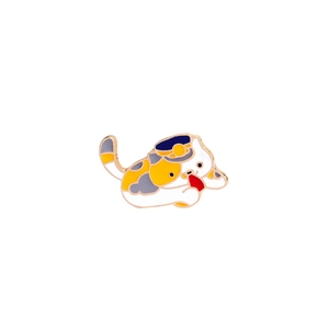 Detail of calico cat enamel pin with blue and yellow hat and polished gold edges