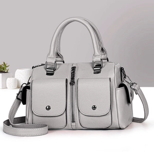 Gray Boston handbag with pebble leather texture and crossbody strap in a modern setting