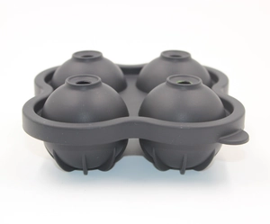 Detail of dark grey four-hole spherical silicone ice mold in a clean two-part design