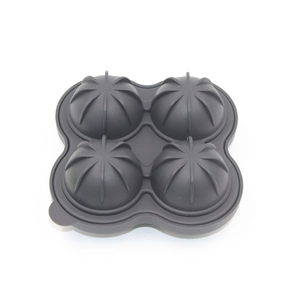 Detailed view of dark grey 4-hole spherical silicone ice mold with orange petal texture