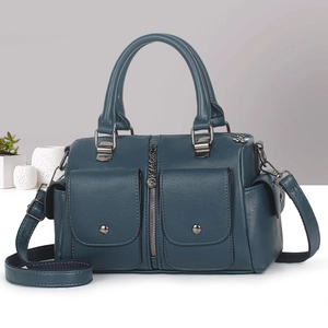 Detail of blue lychee grain leather handbag with dual pockets and metallic hardware