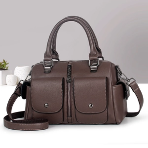 Detail view of brown pebbled Boston bag with magnetic pockets and dark hardware