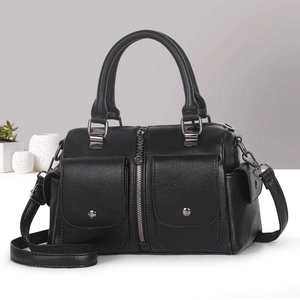 Detail of black pebbled leather handbag featuring textured finish and gunmetal hardware