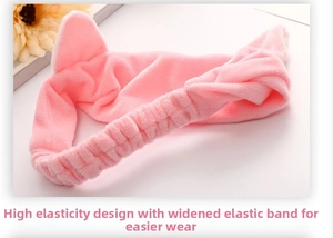 Detail view of pink plush cat ear headband with widened elastic band for skin care