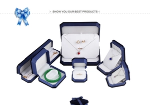 Collection of navy velvet jewelry boxes for rings and necklaces on a clean white background