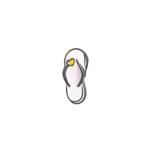 Detail shot of a cute white flip-flop enamel pin with a yellow heart on grey straps