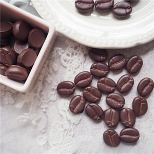 Macro shot of realistic resin coffee bean DIY charms for Halloween craft and jewelry