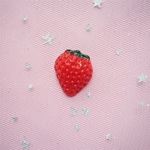 Detailed view of realistic red resin strawberry for DIY phone case and crafts
