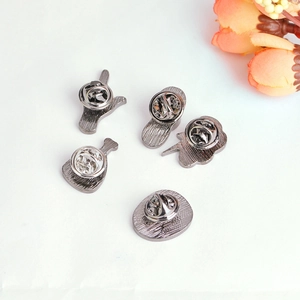 Detailed back view of five gun-metal enamel pins showing the secure butterfly clasps