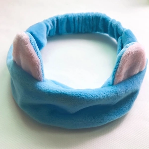 Close-up of soft blue plush cat ear headband with pink inner lining details