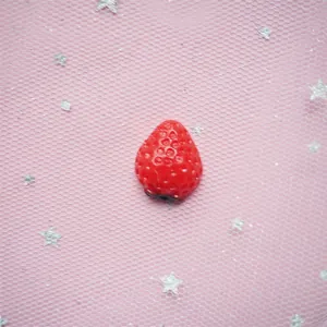Realistic red resin strawberry charm detail for DIY phone cases and hair clips