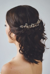 Detail of bridal hair comb with gold wires, white pearls and sparkling crystals