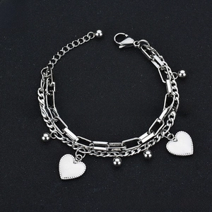Detail of double-layer stainless steel bracelet with heart charms and lobster clasp