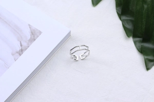 Minimalist double-layered S925 silver hexagonal open ring on white fabric background
