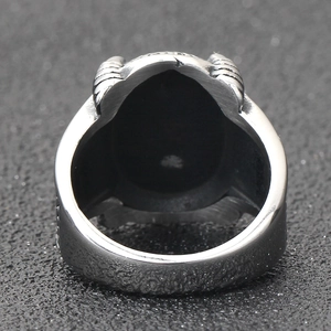 Macro side view of vintage silver steel ring with relief texture and gothic details