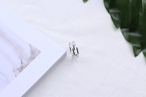 Minimalist S925 sterling silver double-layer open ring on a clean white textured fabric