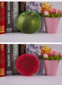 Detail of cute plush fruit coin purses in apple and dragon fruit shapes with zippers