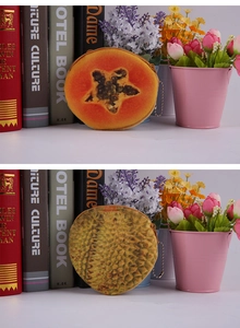 Detail of plush fruit coin purses showing realistic papaya and durian prints with metal chain