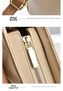 Detailed macro view of high-quality gold metal hardware buckles and zippers on handbag