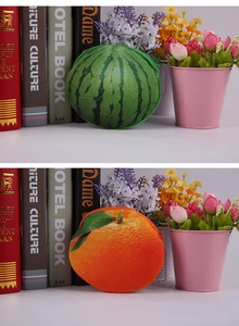 Detailed view of plush watermelon and orange coin purses with metal zippers and bead chains