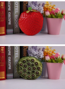 Detail of plush fruit coin purses featuring cute strawberry and lotus pod designs