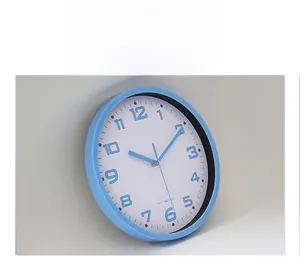 Detail view of the 10-inch blue quartz wall clock featuring a minimalist white dial