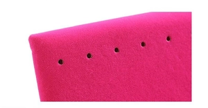 Macro shot of pink flocked earring display stand with precision holes for jewelry storage