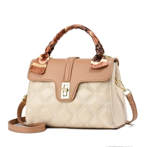 Women's quilted color-block handbag in cream and brown with decorative silk scarf