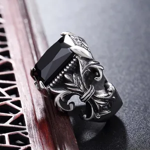 Vintage Gothic men's titanium ring featuring a large rectangular black gemstone and fleur-de-lis
