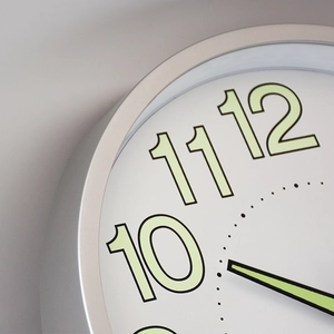 12 inch luminous wall clock with silver frame and large green glow-in-the-dark numbers